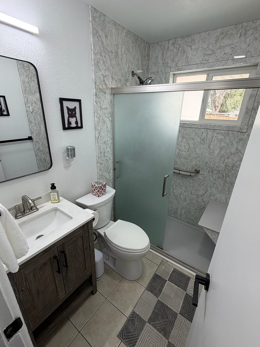 Walk-in shower with shower seat. Window adds natural light and brand new LED lighting really brightens the space. Hair dryer and starter bath products included.