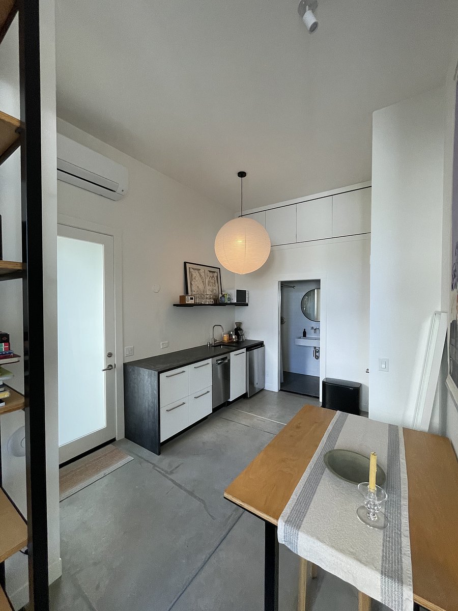 View across dining area, kitchenette and bathroom beyond.