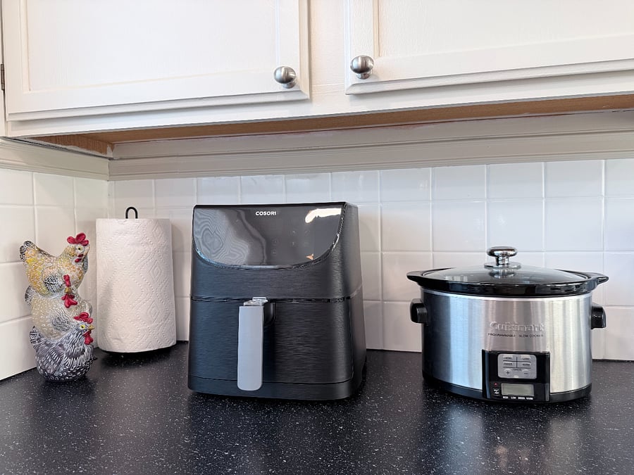 Kitchen stocked with essentials, including an air fryer, slow cooker, and espresso machine.