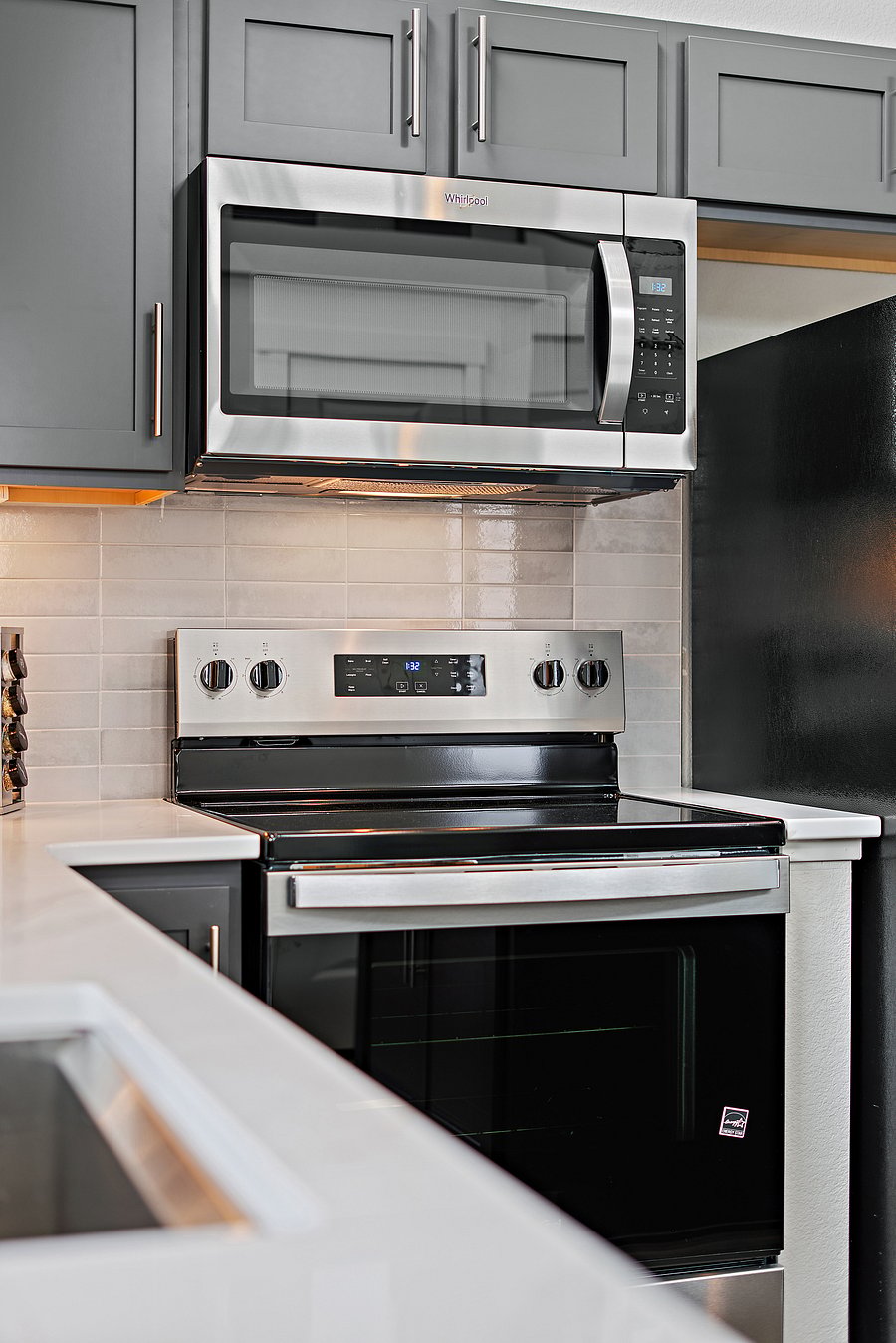 Full-size electric range, oven, and microwave for easy home-cooked meals.