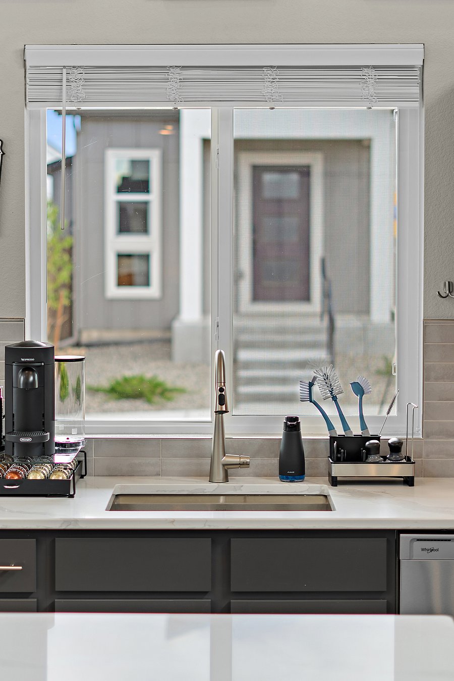 Nespresso Vertuo Plus Deluxe with milk frother and assorted coffee pods.