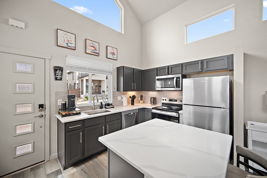 Stainless steel appliances, generous counter space, and island seating for two.
