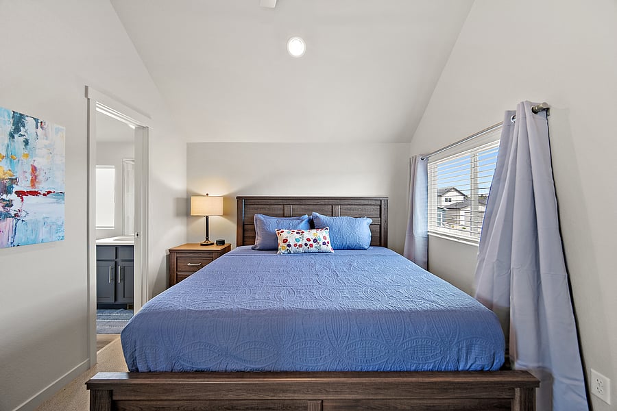 Your upstairs primary retreat with comfortable furnishings and a private bath.