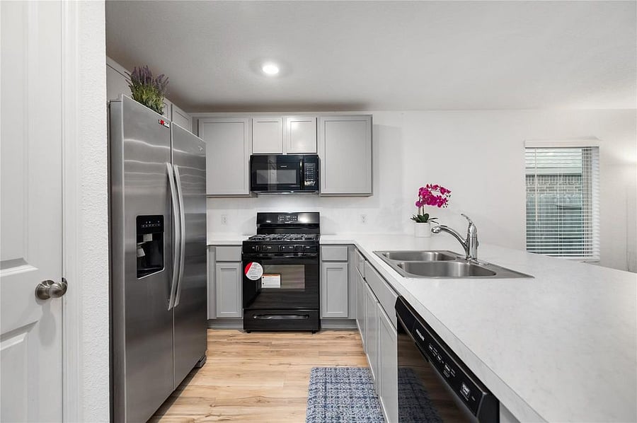 Modern kitchen with stainless steel appliances.