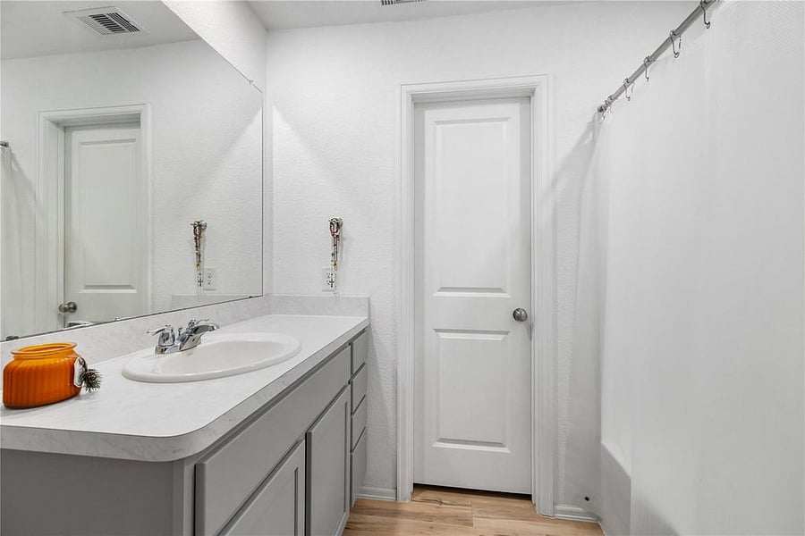 Primary bathroom with walk-in closet. Shower soaking tub combo.