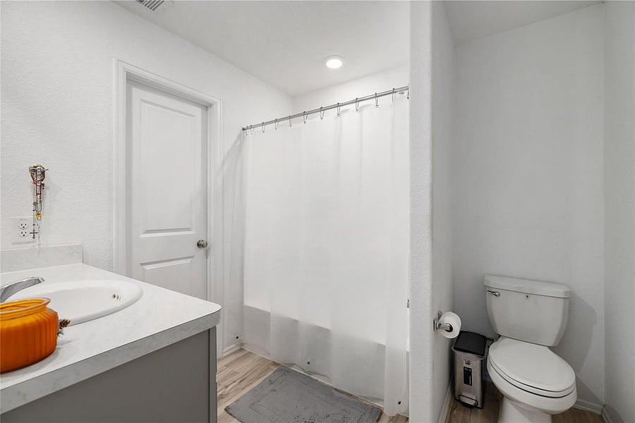 Primary bathroom with walk-in closet. Shower soaking tub combo. (View from corner)