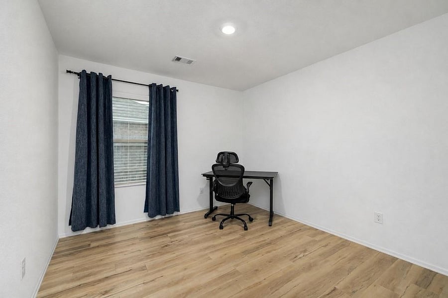 Third bedroom offers no carpet. Office space with desk and chair. 