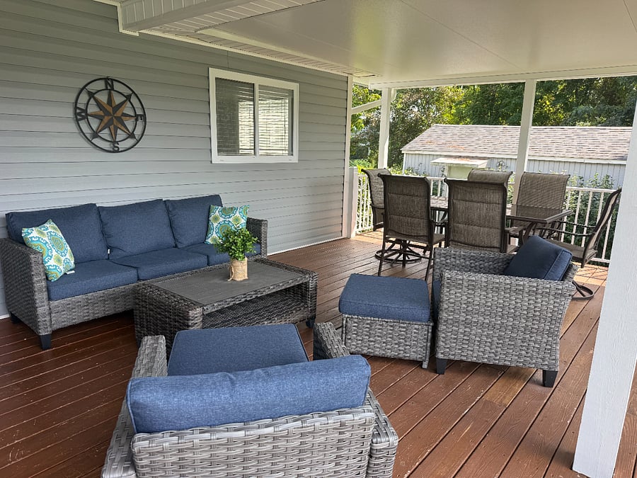 Patio table and conversation lounge set on covered back porch