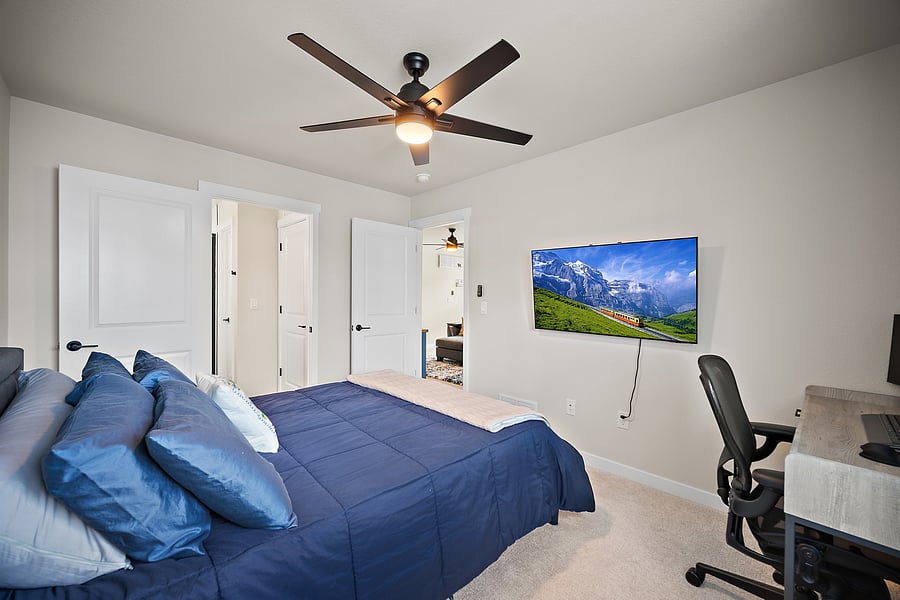 A bedroom made for downtime, with a 50" Smart TV.