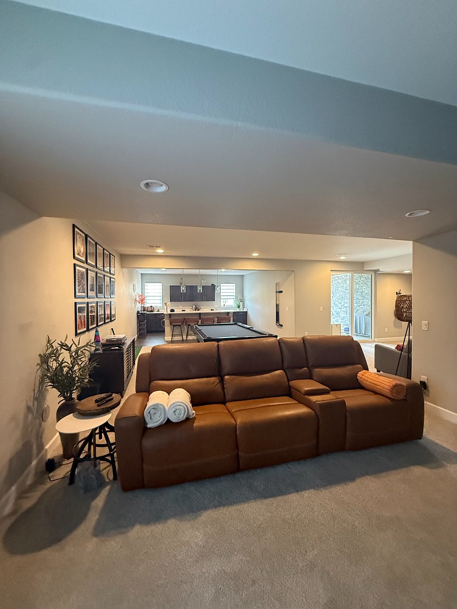 Basement entertaining area. Great for watching movies. includes a wet bar