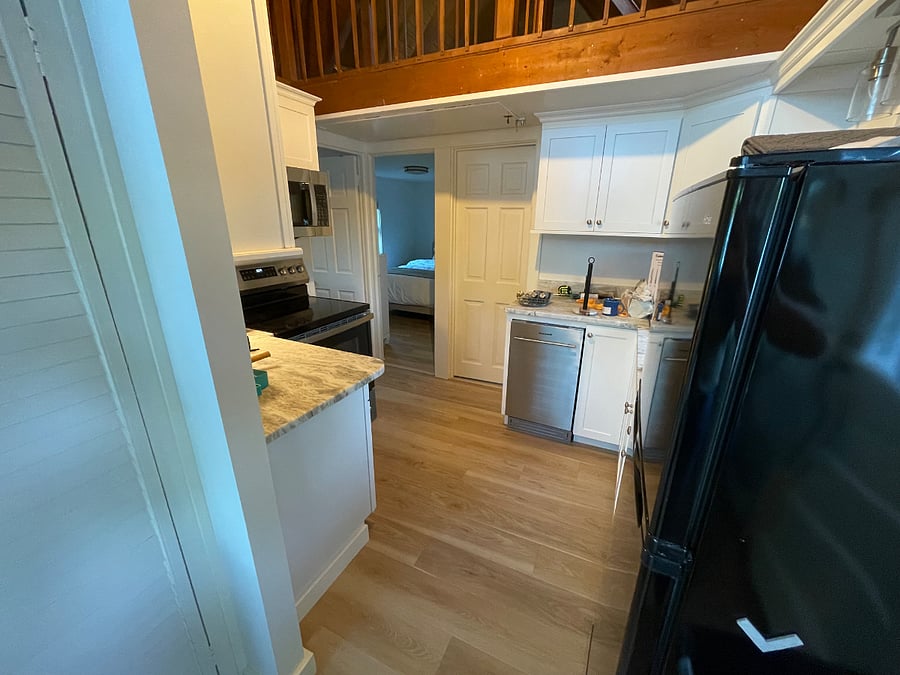 Behind me is the living room, which leads to kitchen which has all new appliances and cabinets. Cathedral ceiling gives feeling of open space.