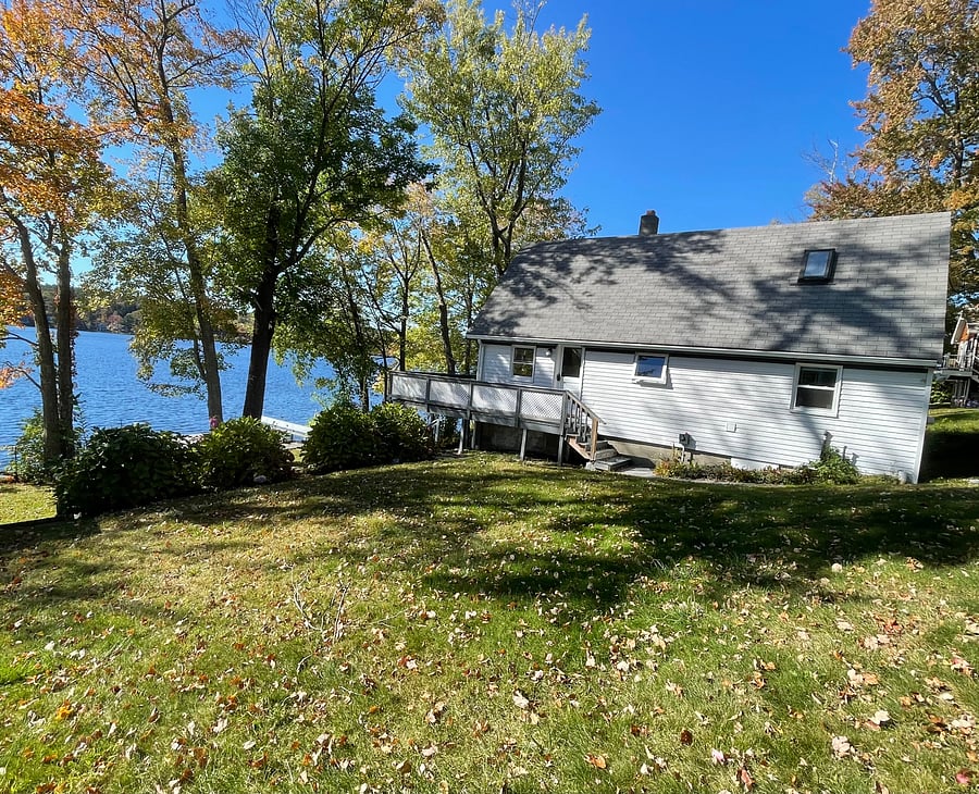 Side view showing lake, deck, and entrance.