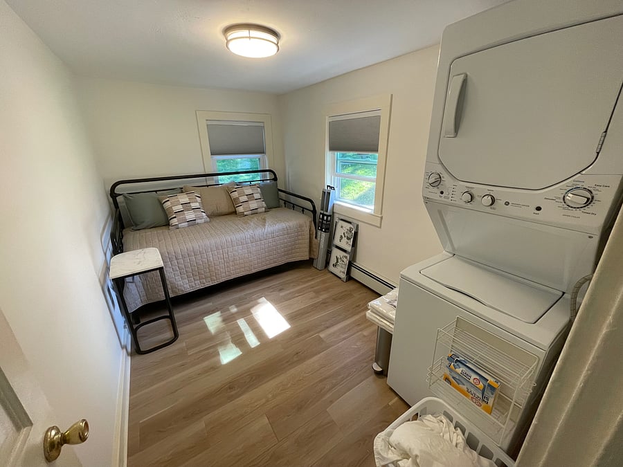 Second bedroom with daybed and laundry setup