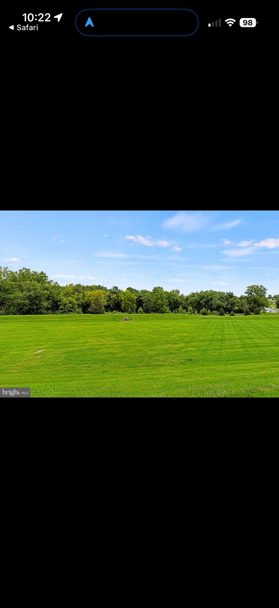 Back patio opens to large green space with walking trails