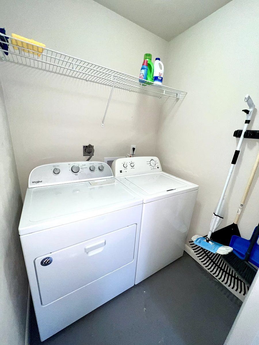 Laundry room w/ full sized washer and dryer.