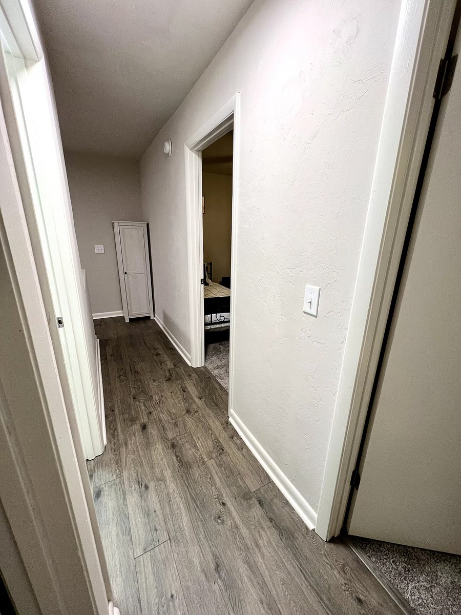 Hallway of bedrooms/ bathroom upstairs ft linen cabinet. 