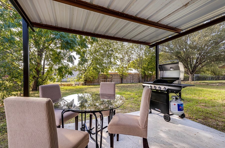 Gas grill in covered patio.