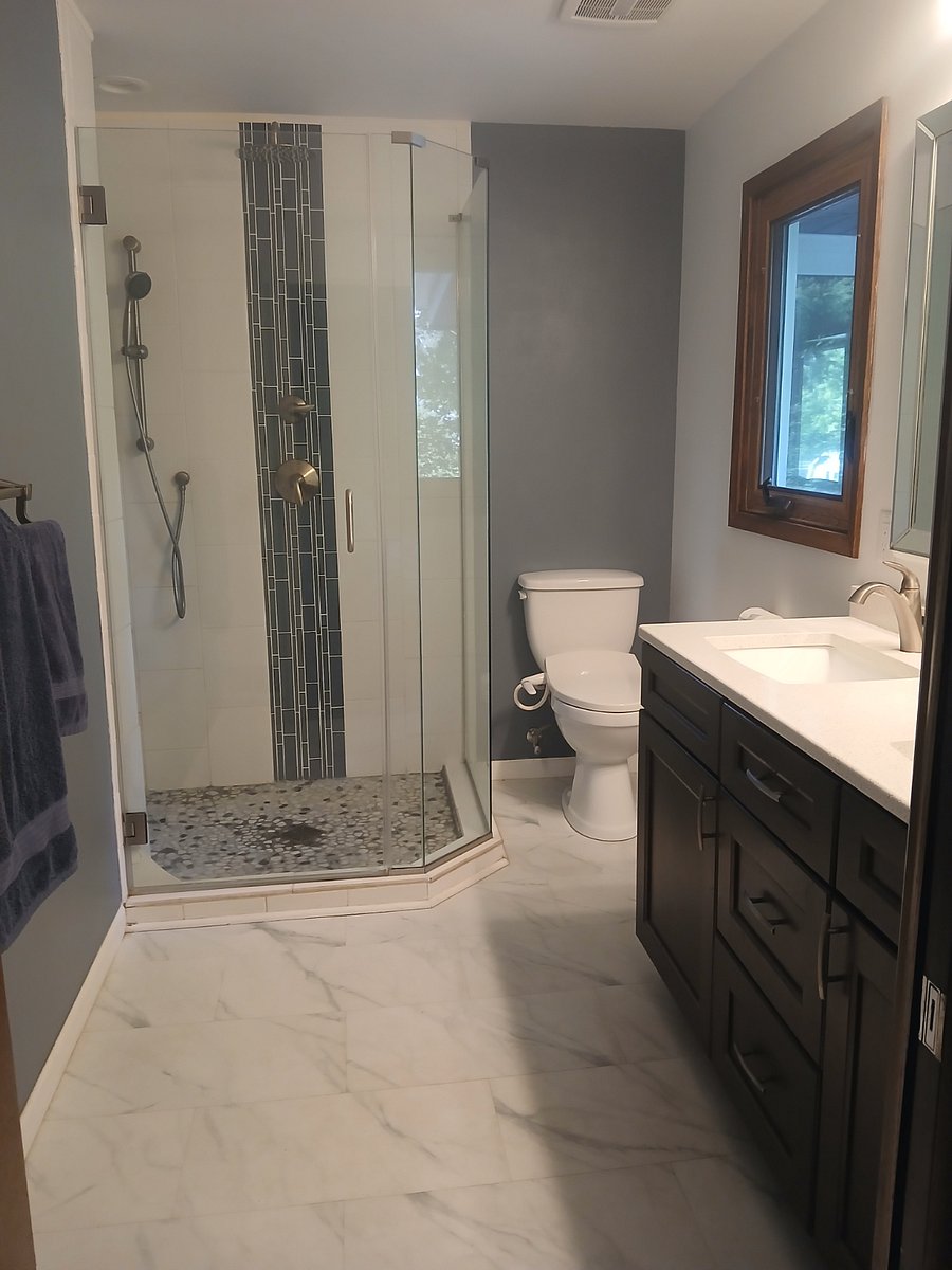 Master Bath, shower has 3 showerheads and sitting bench in corner