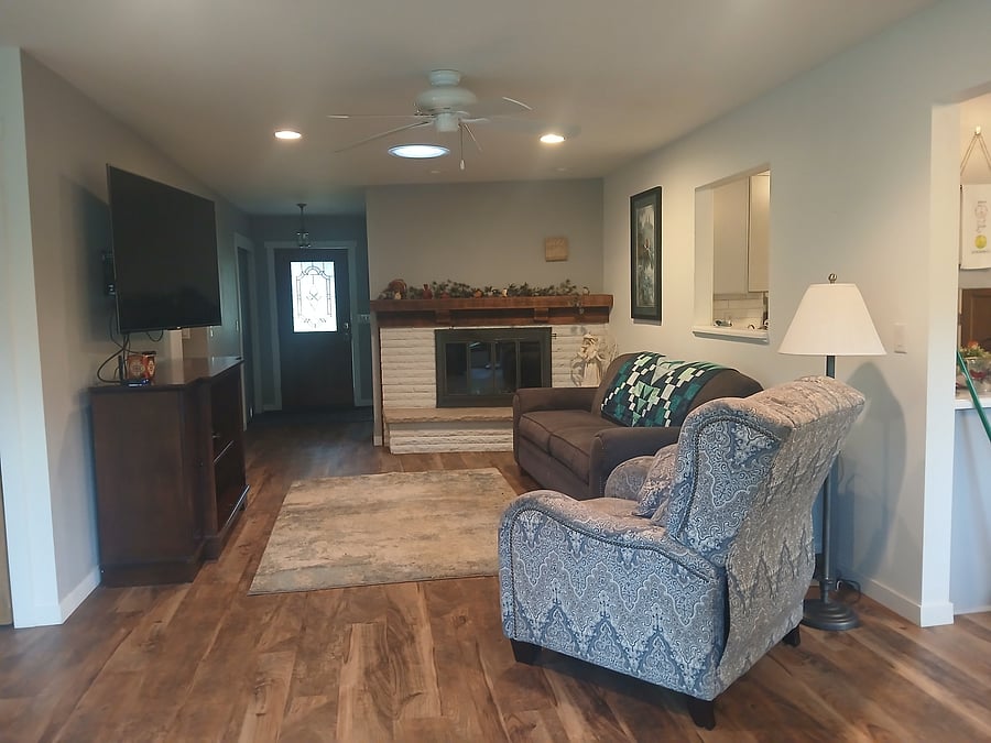 Family room with fireplace from window, looking at main entrance