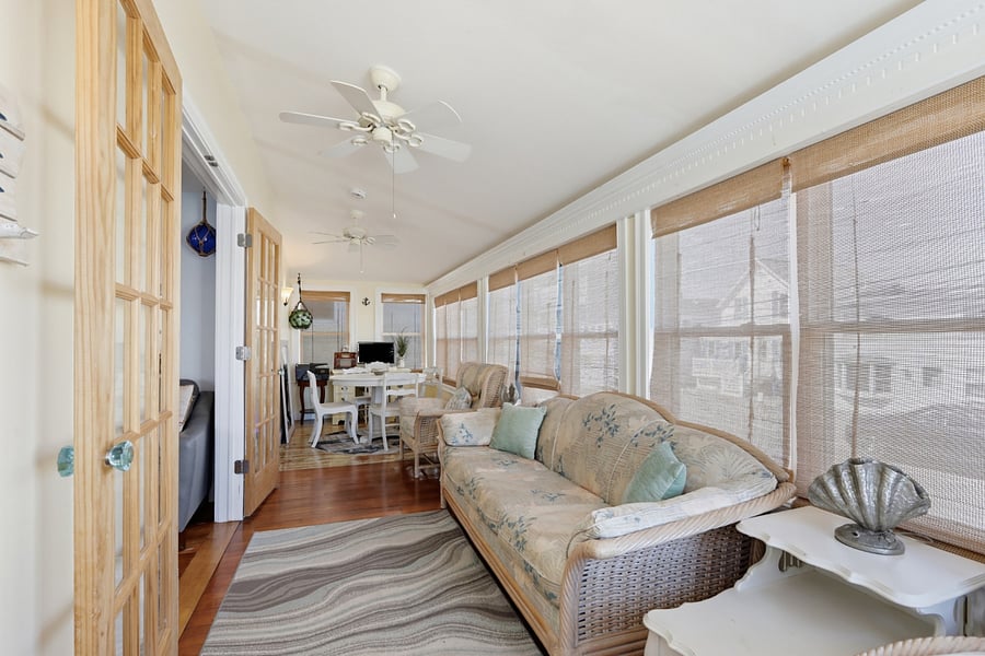 Sunroom with patio furniture and workstation with monitor and printer