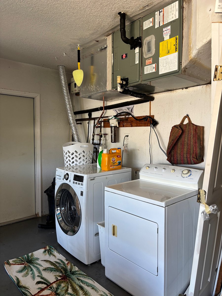 full sized washer and dryer in the garage with ironing board if needed