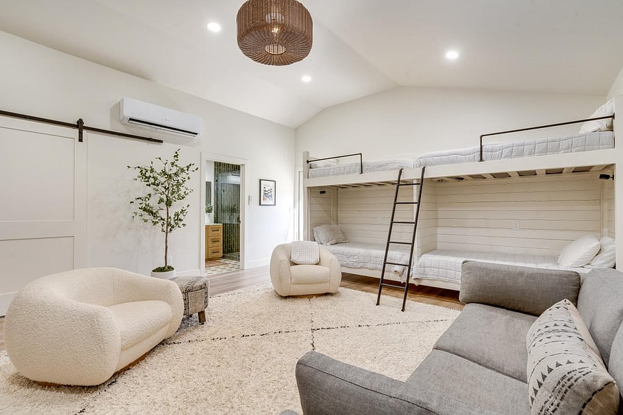 Bunk room with lounge, flat screen tv, laundry room, full bathroom. Leads to second hard. 