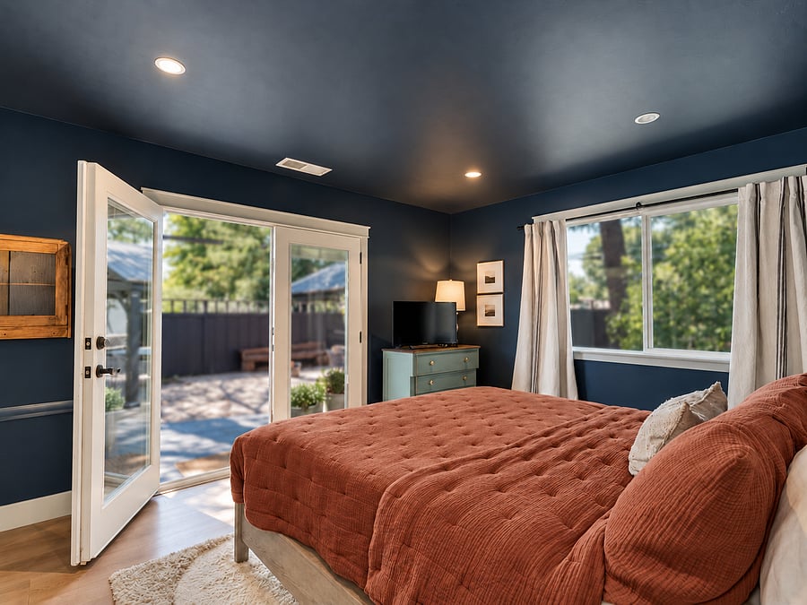 Master bedroom leads to yard with deck. Tv, wall of closets on the left wall. 