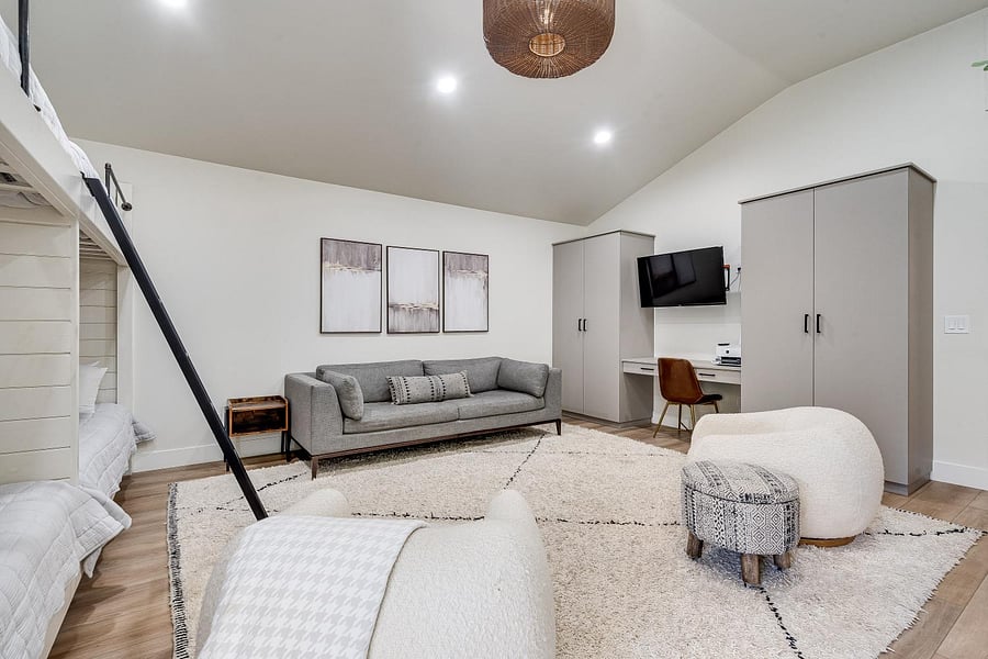 Bunk room with built in bunks and closets, work space and flat screen tv. 