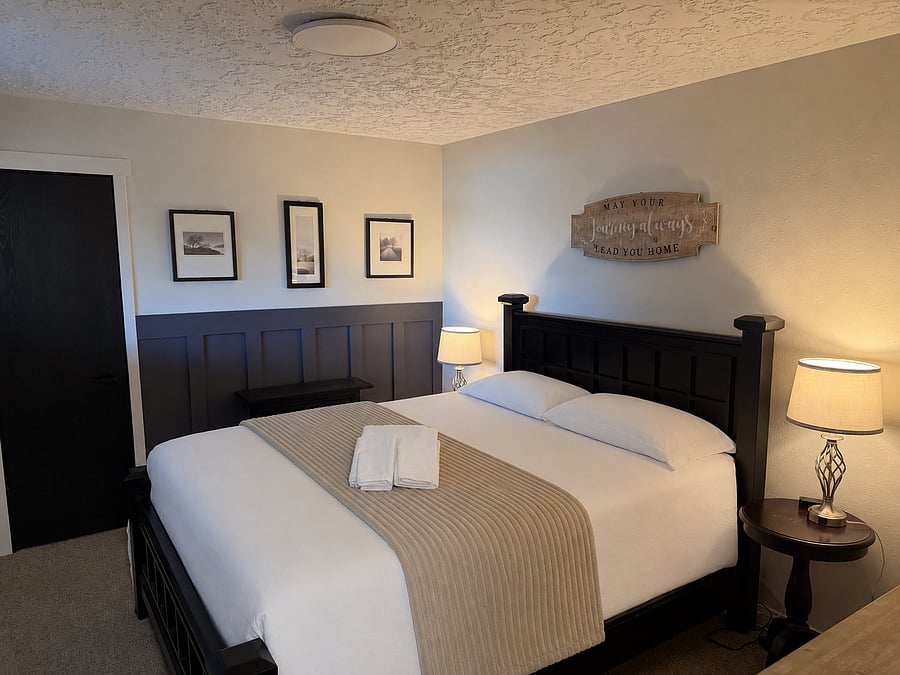 Bedroom with queen-sized bed and smart TV
