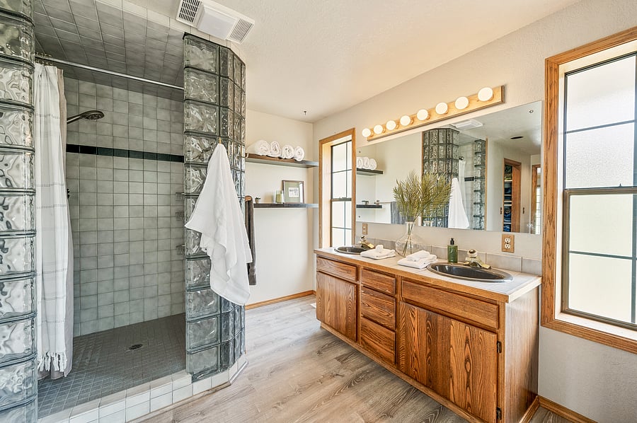Primary bathroom that includes 2 walk in closets