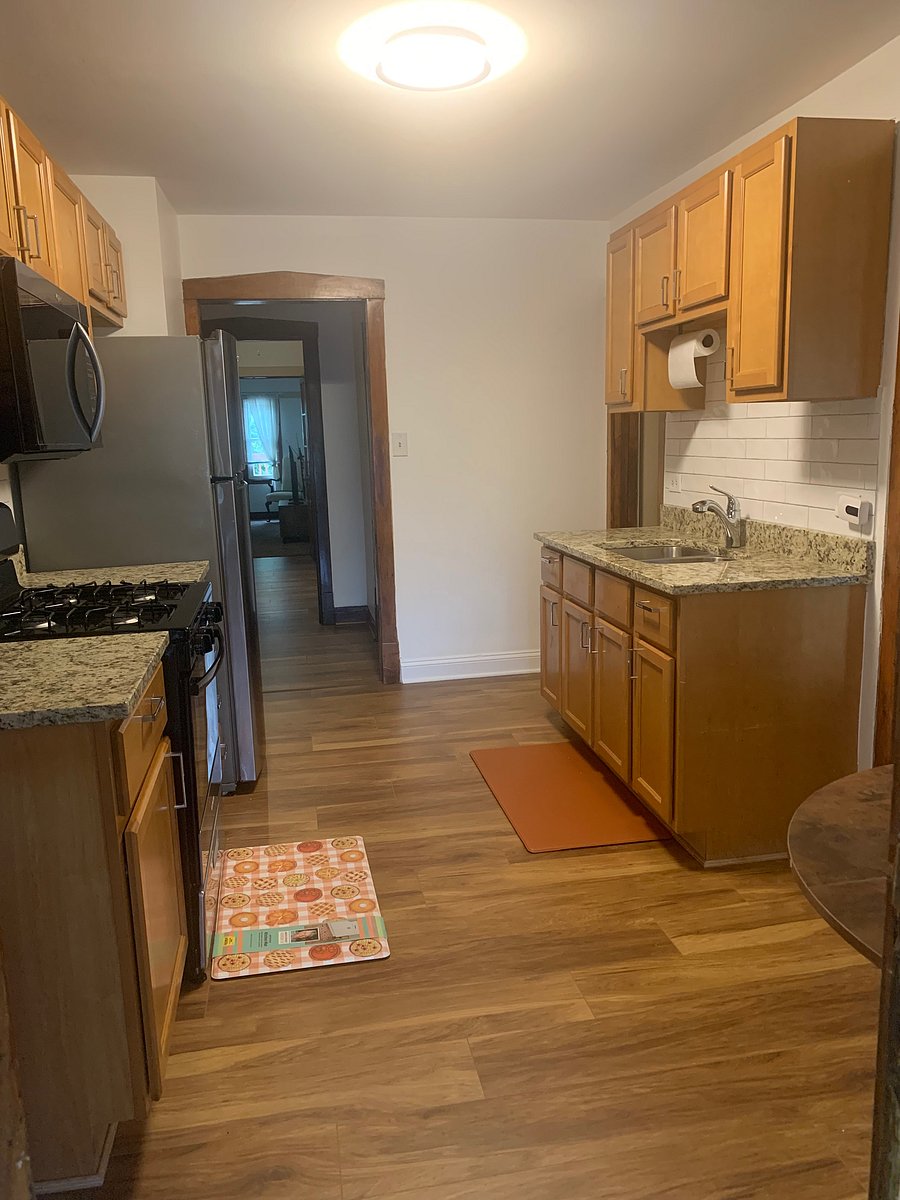 Kitchen with new stove, granite countertops microwave and laminate flooring.  Kitchen fully furnished with new toaster and coffee pot, etc. Coin operated washer and dryer off pantry in kitchen and second pantry has rolling cart and shelving for your use. 