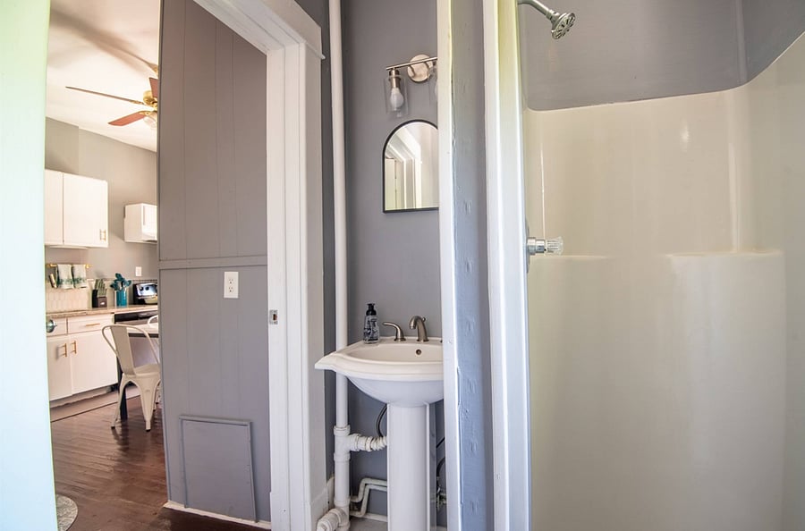Well-maintained and organized bathroom offers a fresh and tidy space. The stand-up shower is simple to use, and essentials are stocked for convenience. It's a comfortable, functional spot for refreshing.