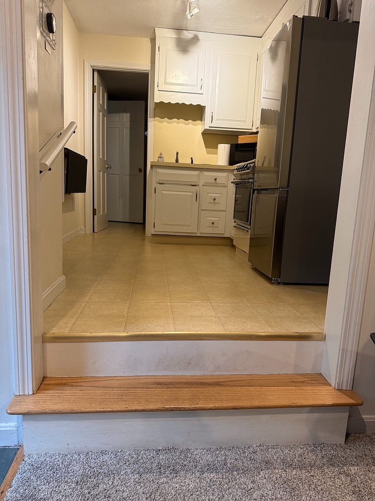 Step from living room into kitchen