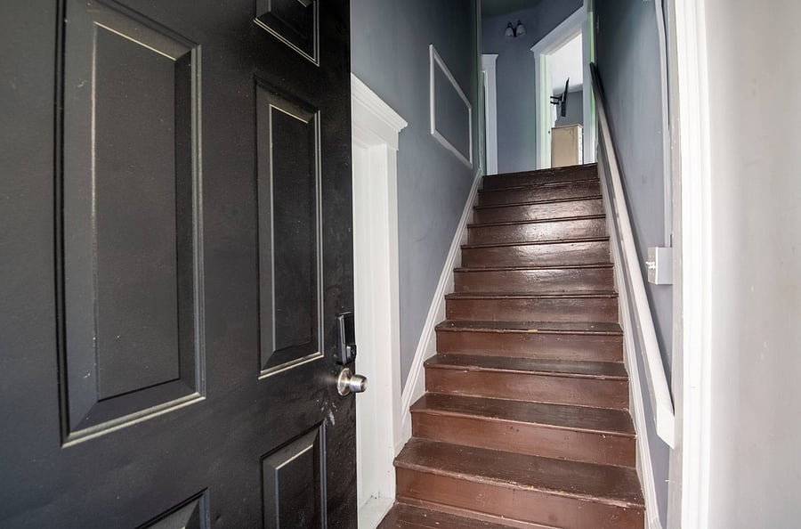 Step inside and feel the warmth. Our beautifully finished wooden staircase guides you straight into the heart of your home-away-from-home.