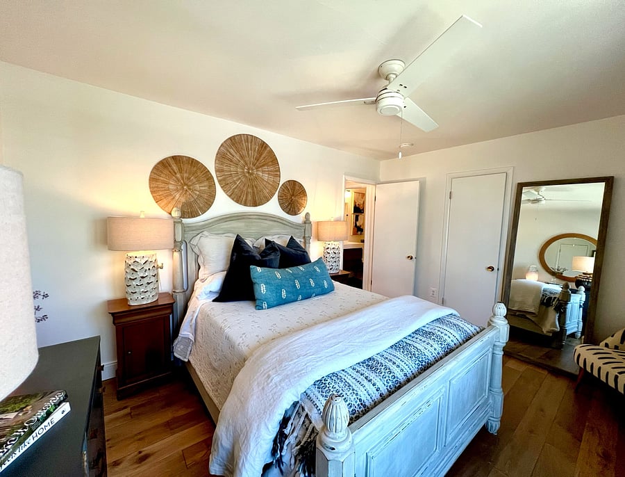 Primary bedroom with large mirror.