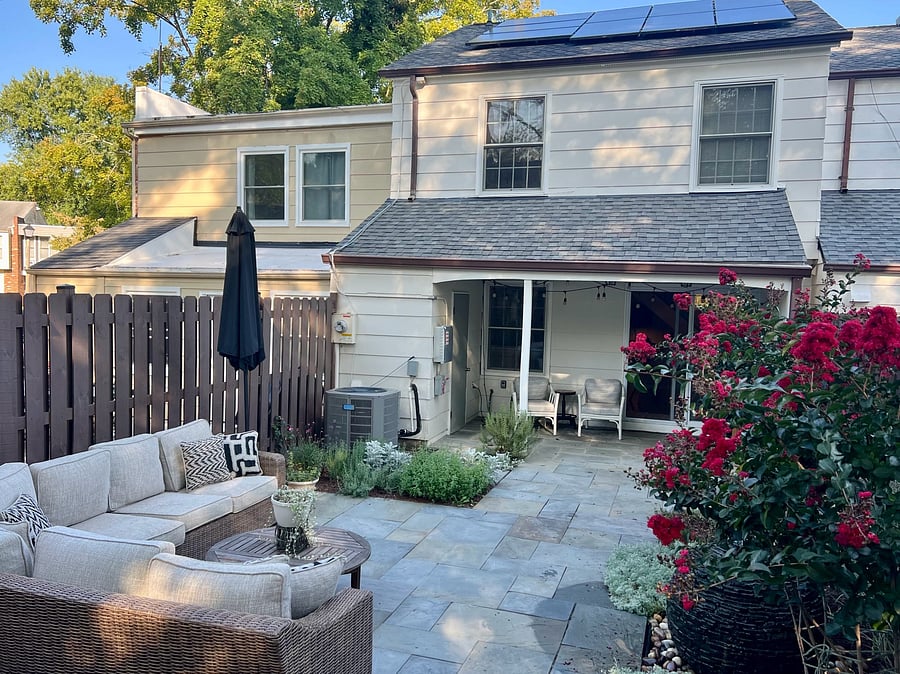 Little covered porch is a great spot to escape the rain and still take in the backyard.