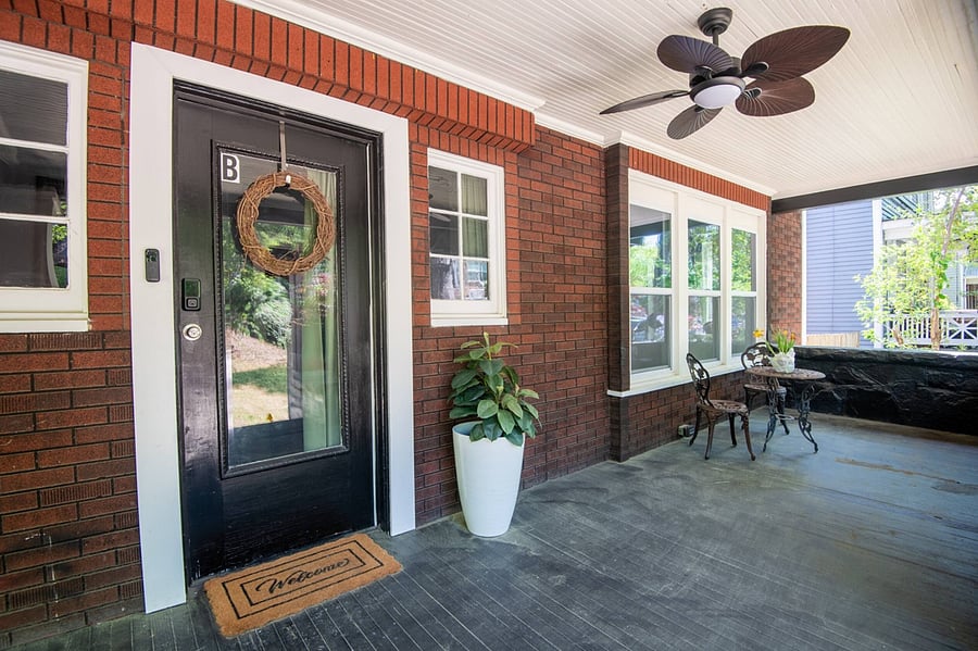 Unit B; Charming front porch, perfect for morning coffee or relaxing in the evening. Features a cozy seating area, stylish décor, and a welcoming entrance to your home-away-from-home.