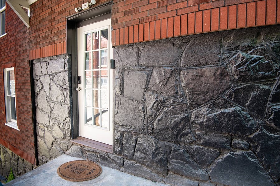 Unit A; The front entrance, adorned with faux stone, adds character and a touch of rustic charm.