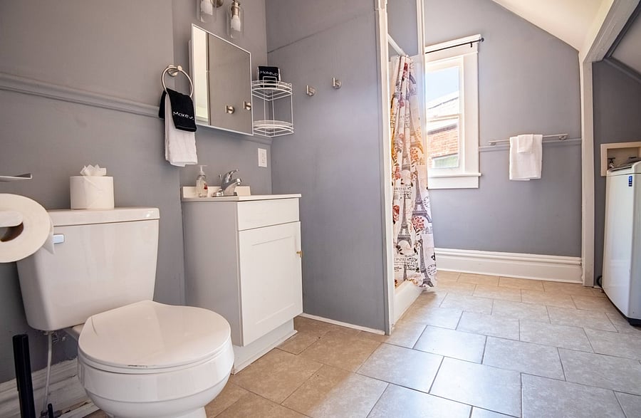 The bathroom features polished tile flooring, adding a clean and contemporary touch.