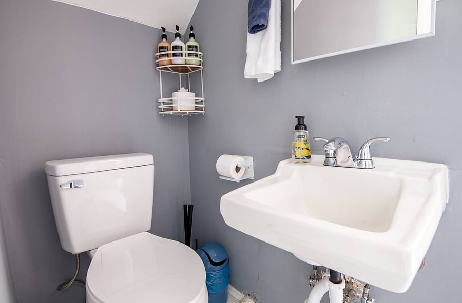 Simple, clean, and efficient, the compact bathroom features a step-down entry into the stand-up shower and all the essentials for a comfortable stay.
