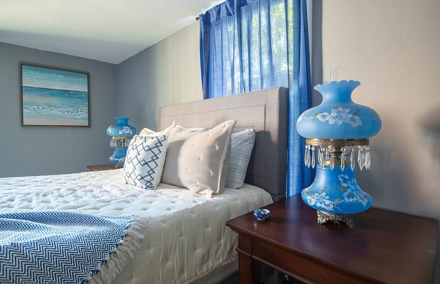 This inviting bedroom blends vintage charm with everyday comfort, offering a queen bed, TV, and generous storage space so you can truly settle in and feel at home.