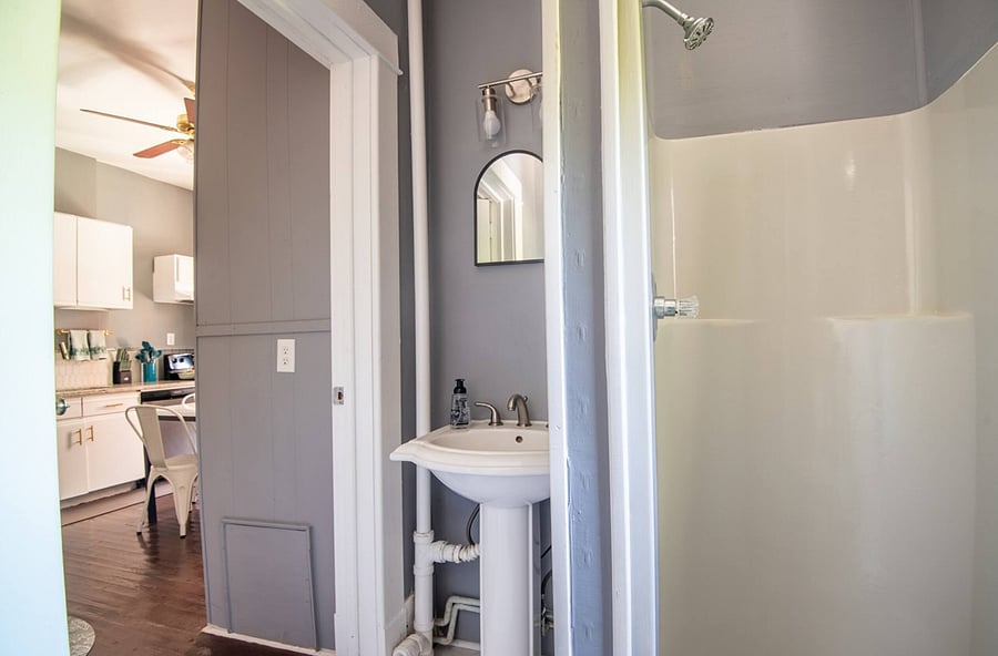 Well-maintained and organized bathroom offers a fresh and tidy space. The stand-up shower is simple to use, and essentials are stocked for convenience. It's a comfortable, functional spot for refreshing.