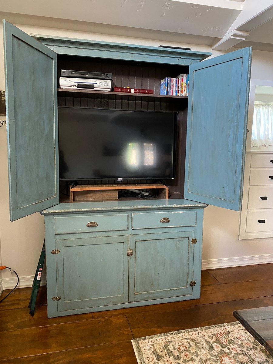 The Smart TV is housed in an armoire in the living space. 