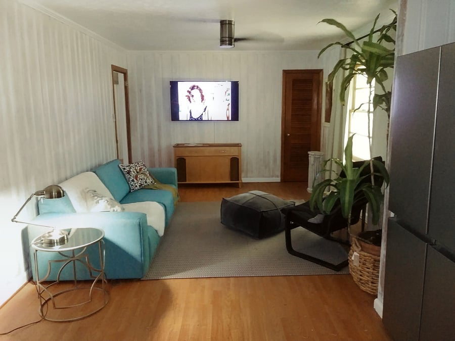 Spacious living area with comfortable seating, TV, and ceiling fan-a welcoming place to unwind and recharge after work, clinicals, or classes.