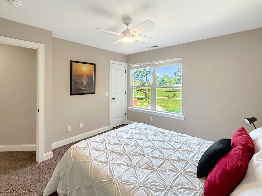 Full bedroom at end of hall with beautiful view of area
