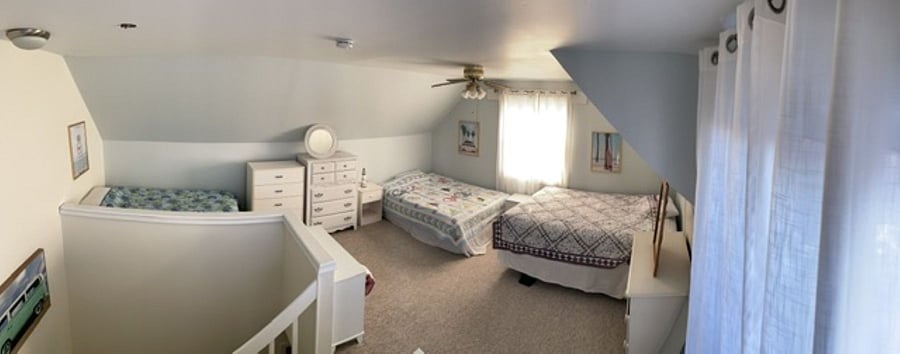 Loft bedroom has 4 beds: 2 queen, 1 double, 1 twin. Loft has slider door to the balcony.