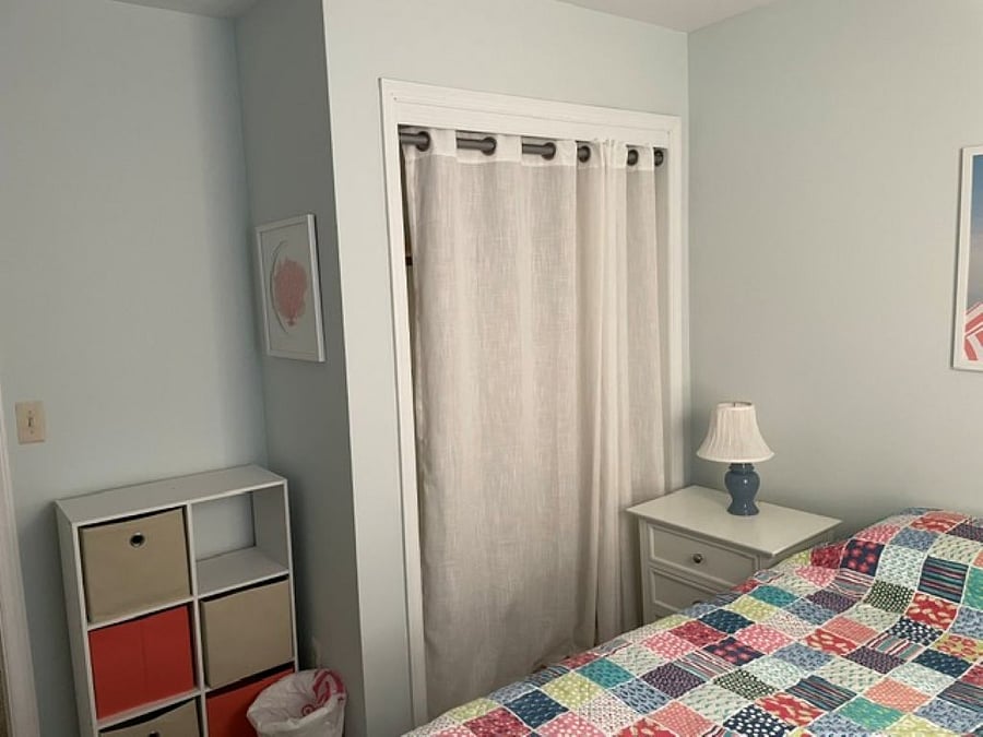 Queen bedroom with large closet and portable work station.
