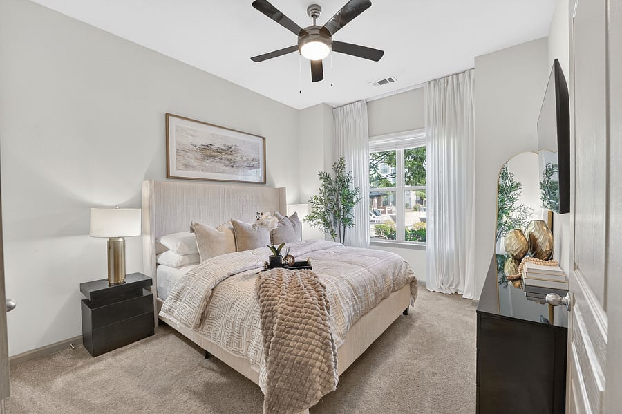 The serene primary bedroom is a true sanctuary - a plush king-sized bed dressed in premium hotel-grade linens, soft layered bedding, a designer upholstered headboard, and warm ambient lighting.