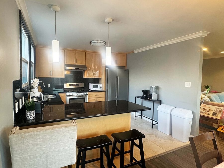 Shared kitchen with island and bar stools