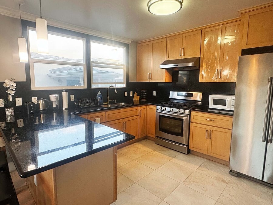 Fully equipped shared kitchen with stainless steel appliances
